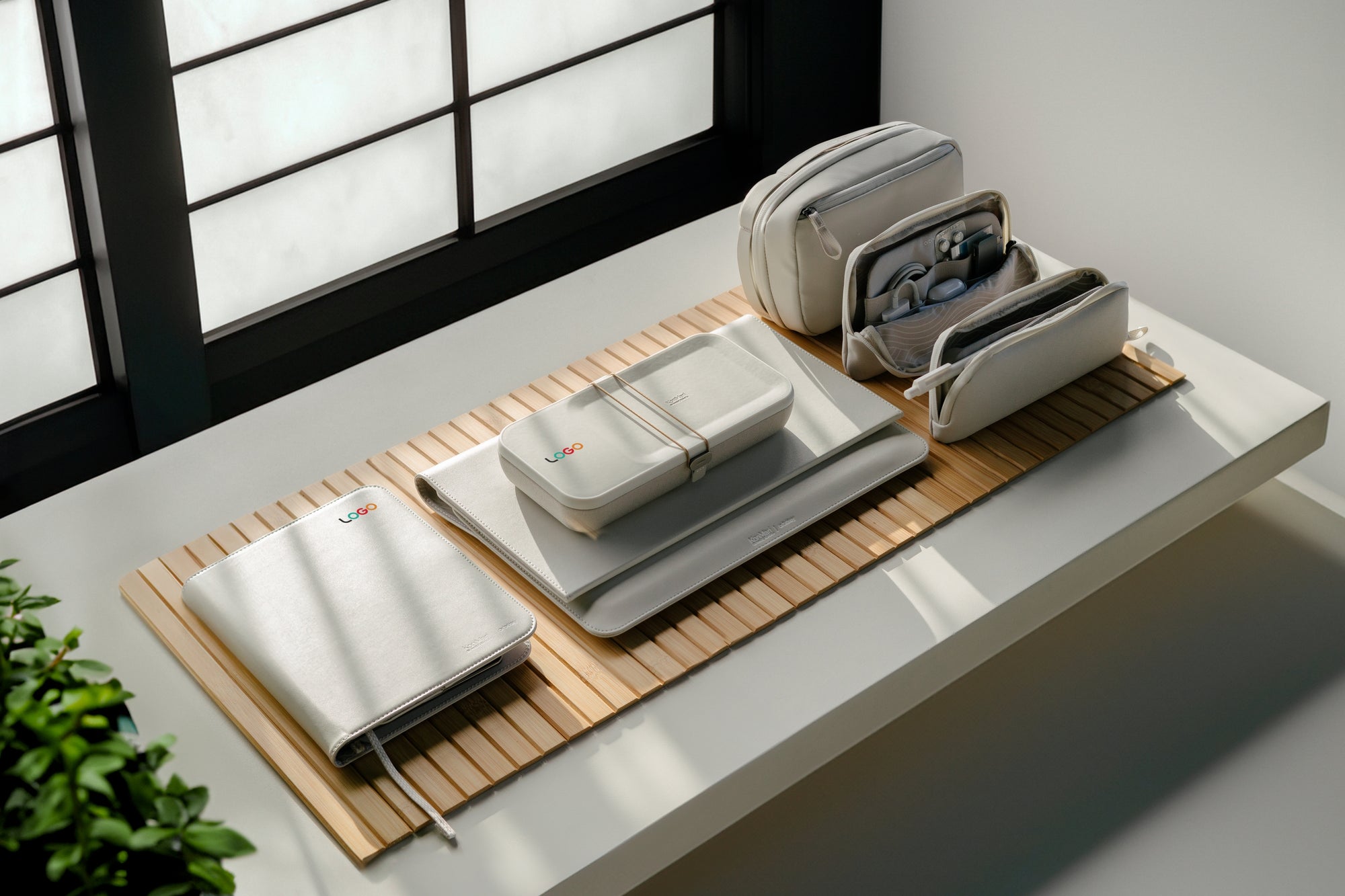 Co-branded Orbitkey collection laid out on a timber desk